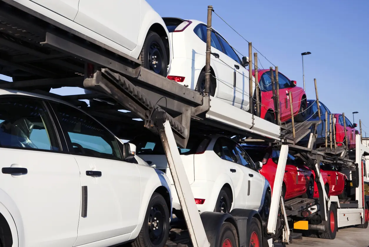 New Project (5) Cars loaded on a transport truck trailer.