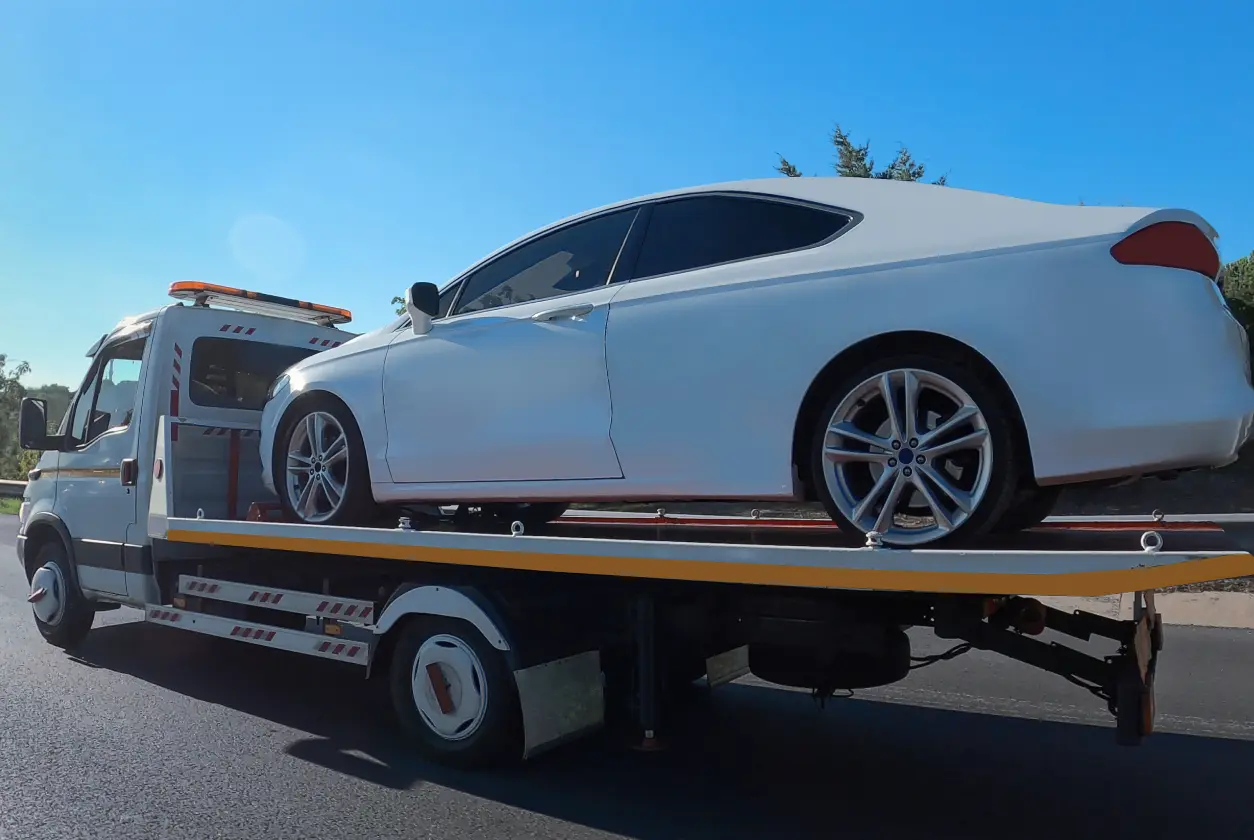 New Project (8) Tow truck carrying a white car.