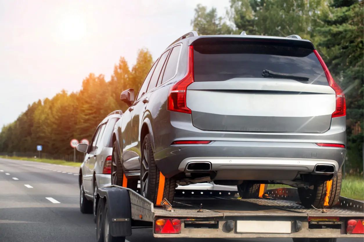 New Project(3) SUV on a trailer being towed.