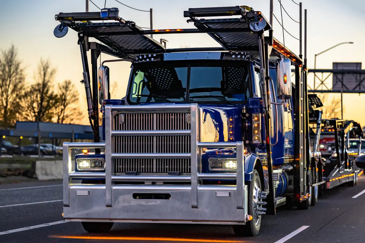 Blue car carrier truck on the road.